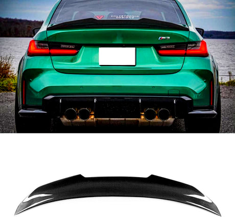 A green sports car with a "Valvetronic Designs" sticker on the rear window and an "M3" badge is parked by a lake. Below, a black carbon fiber car spoiler is displayed.