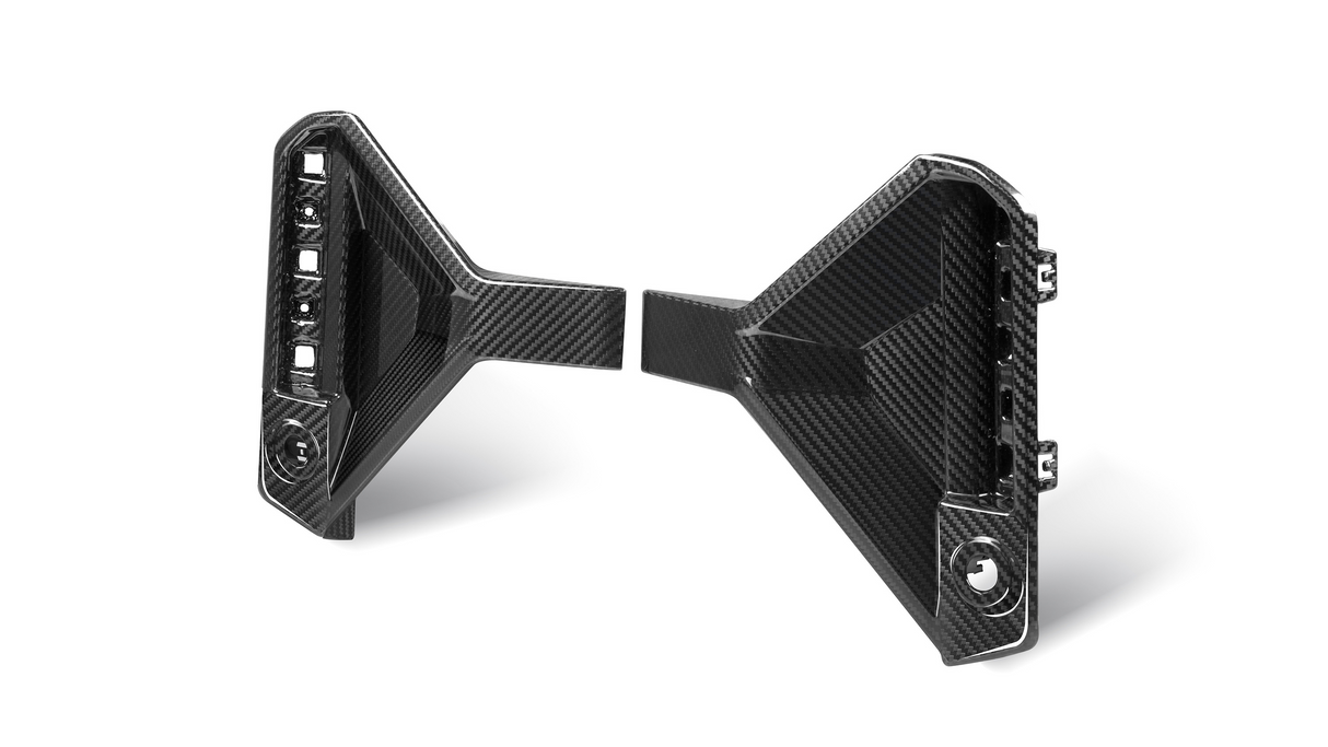 Carbon fiber bracket with geometric design, displaying attachment points. Positioned on a white background, highlighting its sleek, angular appearance. The material's texture is visibly detailed.
