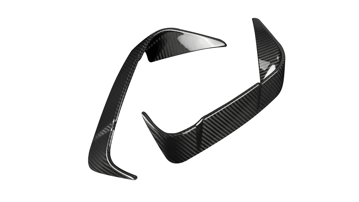 Two carbon fiber car parts with a sleek, aerodynamic design are positioned against a plain white background, displaying a glossy, reflective surface pattern.