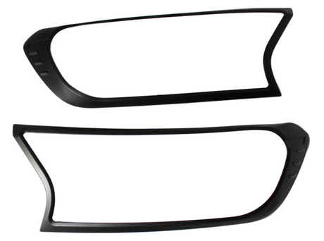 Two black plastic frames, resembling headlight covers, are positioned horizontally against a plain white background. Each frame has an asymmetric, modern design with smooth curves and sharp angles.