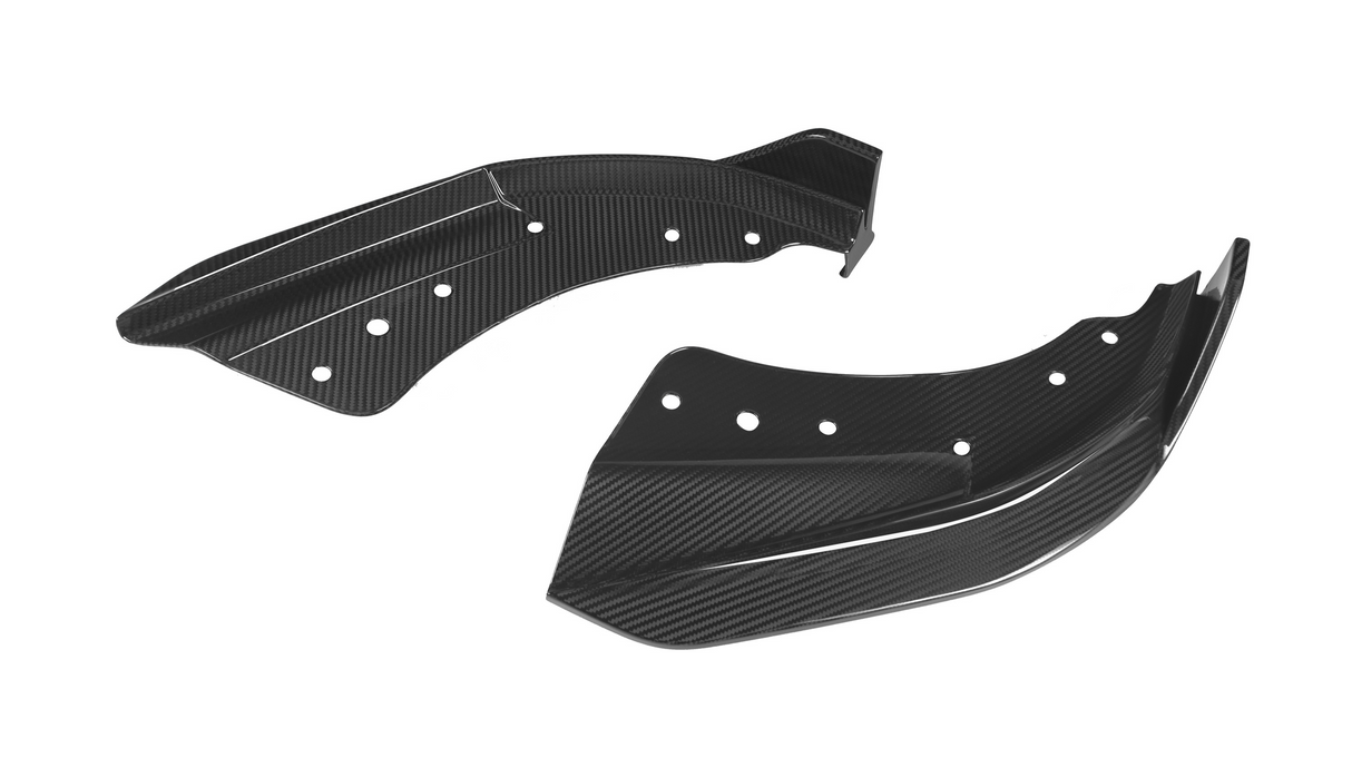 Two black carbon fiber automotive winglets with multiple circular cutouts rest against a white background, showcasing a sleek, aerodynamic design.