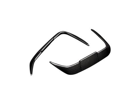 A pair of sleek, carbon fiber sunglass frames with pointed temples, positioned in a diagonal orientation against a plain white background.