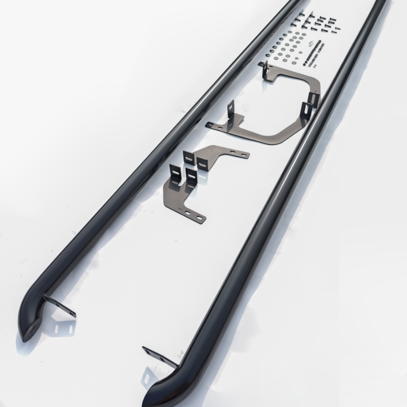 Two black metal bars with mounting brackets and holes lie on a table displaying installation instructions. Surrounding them are small hardware pieces arranged neatly.