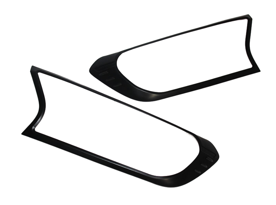 Two black, elongated plastic frames with rounded edges, possibly for vehicle lights, lay on a white background. Each frame features minor indents near one end, adding subtle detailing.