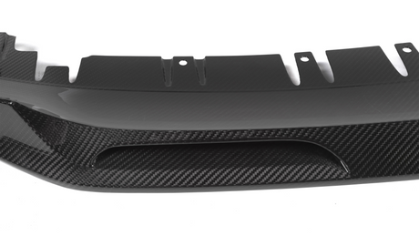 A carbon fiber car diffuser with a sleek, aerodynamic design features curved fins and vent openings, set against a plain white background.