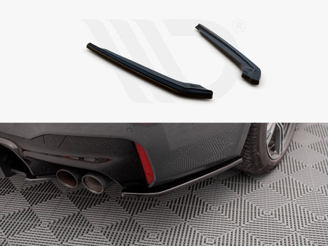 Two black car parts displayed above an installed piece on a car's rear bumper near dual exhaust pipes. The car is parked on a patterned surface.