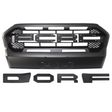 A black vehicle grille with a honeycomb pattern and slots, accompanied by detached black letters spelling "DORF," arranged on a plain white background.