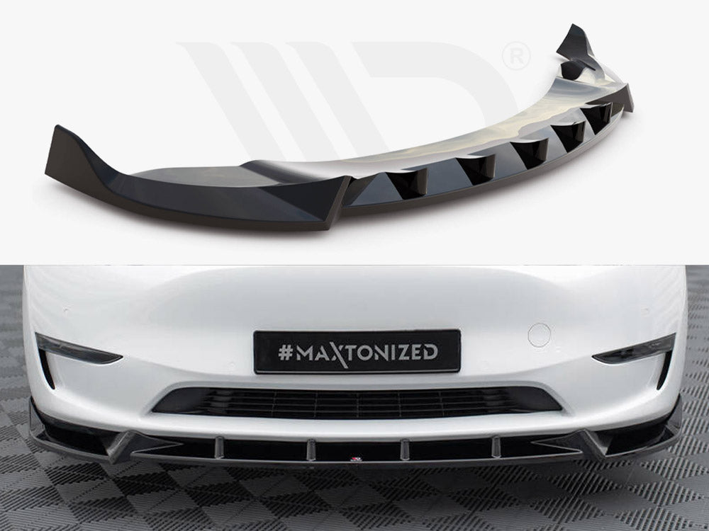 Aerodynamic car bumper extension with a sleek, black finish; installed on a white vehicle's front, which is parked on a checkered surface. License plate reads "#MAXTONIZED."
