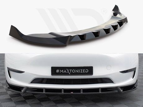 Aerodynamic car bumper extension with a sleek, black finish; installed on a white vehicle's front, which is parked on a checkered surface. License plate reads "#MAXTONIZED."