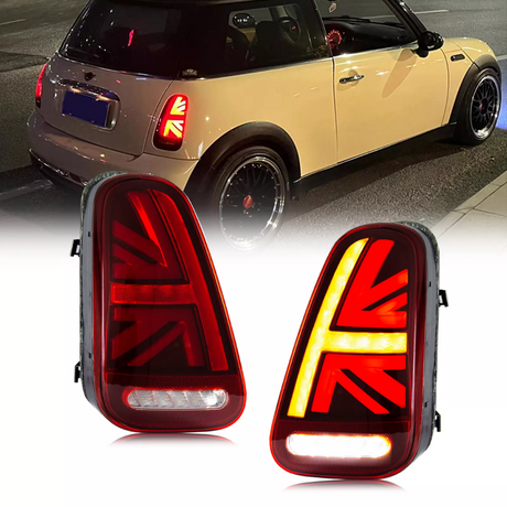 Car taillights display at night, mounted on a Mini Cooper, feature Union Jack design; close-up highlights illuminated red and amber patterns. The vehicle is parked on a city street.