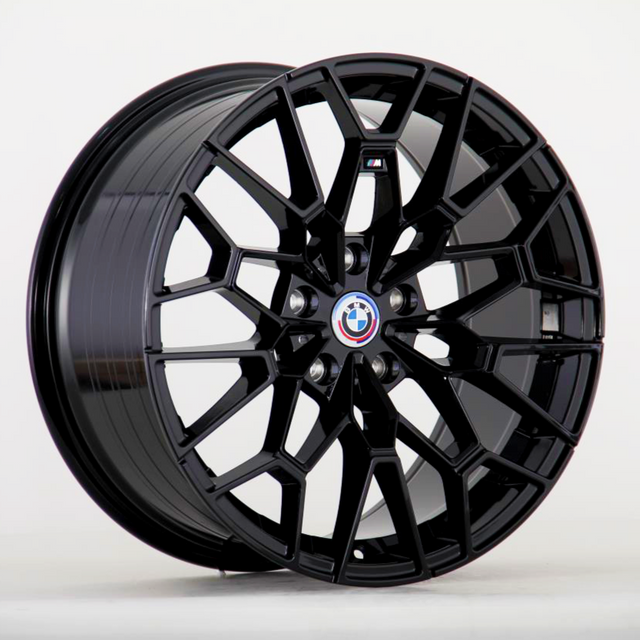 A black, multi-spoke car wheel with the BMW logo and an "M" badge in the center is displayed against a plain white background.