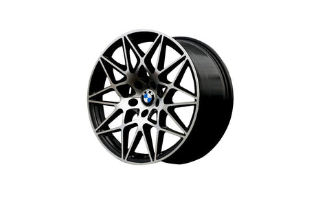 A black and silver alloy wheel with intricate spoke design and a BMW logo at the center, displayed against a plain white background.