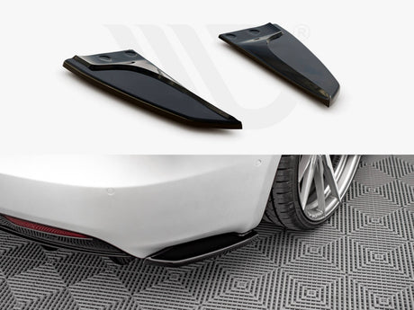Two black aerodynamic fins positioned above, shown detached; below, they are installed on the rear of a white car, parked on patterned flooring, near a rear wheel.