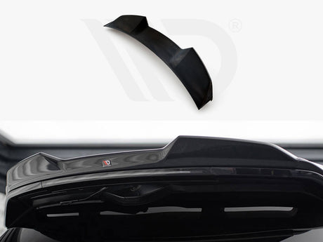 A black car spoiler, designed for aerodynamics, is positioned against a white background with branding visible. Its sleek design complements the rear of a vehicle, enhancing performance aesthetics.