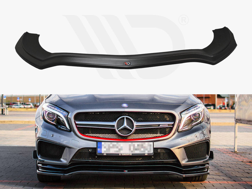 A black front splitter is displayed above a silver Mercedes-Benz sports car with a prominent grille, parked on a paved area surrounded by buildings and cars.