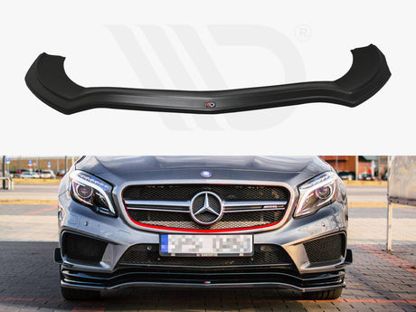 A black front splitter is displayed above a silver Mercedes-Benz sports car with a prominent grille, parked on a paved area surrounded by buildings and cars.