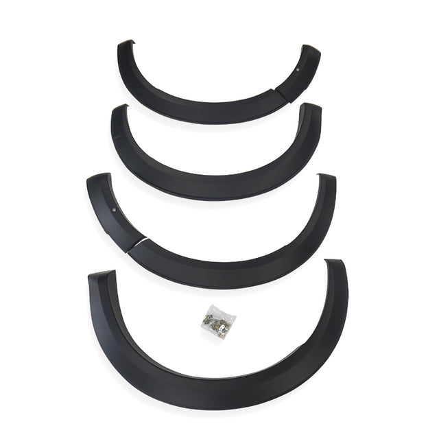 Four black plastic fender flares arranged vertically, each slightly curved, with a small bag of screws below, placed against a plain white background.