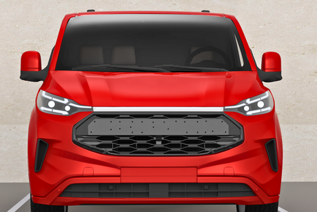 A red vehicle is parked in a parking space, with its front view showing a modern grille design and LED headlights, against a plain beige wall.