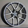 A silver and black Mercedes-Benz AMG alloy wheel rests upright against a neutral background, featuring a five-twin-spoke design and prominent Mercedes emblem at the center.