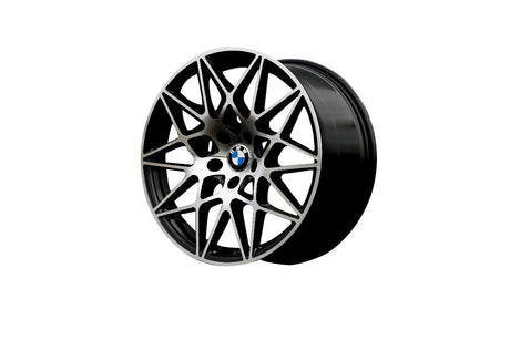 A black alloy wheel with intricate interwoven spokes, featuring a central BMW logo, displayed on a plain white background.