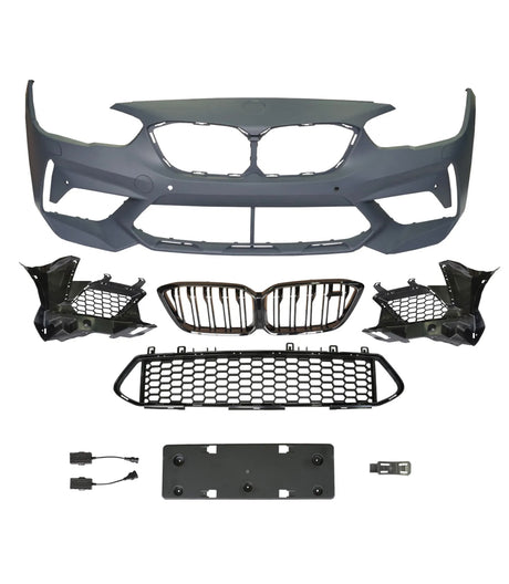 A collection of automotive parts includes a bumper cover, radiator grilles, and mounting brackets arranged on a plain background, suggesting components for vehicle front-end assembly.