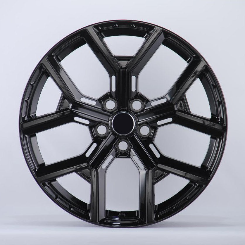 A glossy black car wheel rim features a five-spoke design with intricate detailing, set against a plain white background.