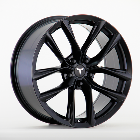 A black alloy wheel with ten sleek spokes displays a Tesla logo at the center. It rests on a plain white background, showcasing its glossy finish and intricate design.