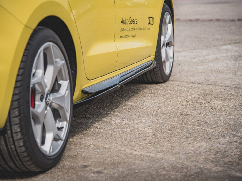 A yellow car's side with silver alloy wheels is parked on concrete. Text reads: "Auto-Special, Modifizierte, Neu Profi & Ausführung, 23617 Audi, www.auto-special-audi.de." The environment is open space.
