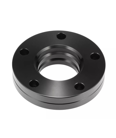 A circular, black metal flange with five evenly spaced holes sits against a plain white background, showcasing its smooth surface and ridges along the inner edge.