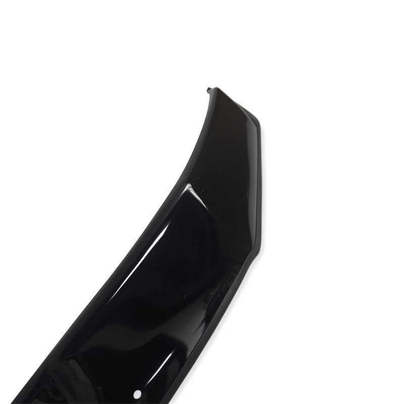 A glossy black car part, possibly a bumper or spoiler, is displayed on a plain white background, highlighting its curved design and shiny surface with a small visible hole.
