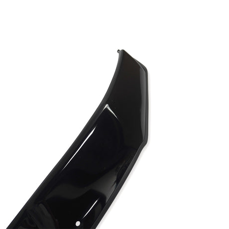 A glossy black car part, possibly a bumper or spoiler, is displayed on a plain white background, highlighting its curved design and shiny surface with a small visible hole.