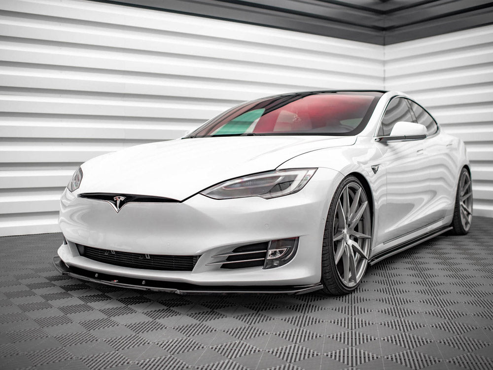 A white Tesla car is parked in a minimalistic garage with patterned flooring and textured white walls, emphasizing its sleek and modern design.