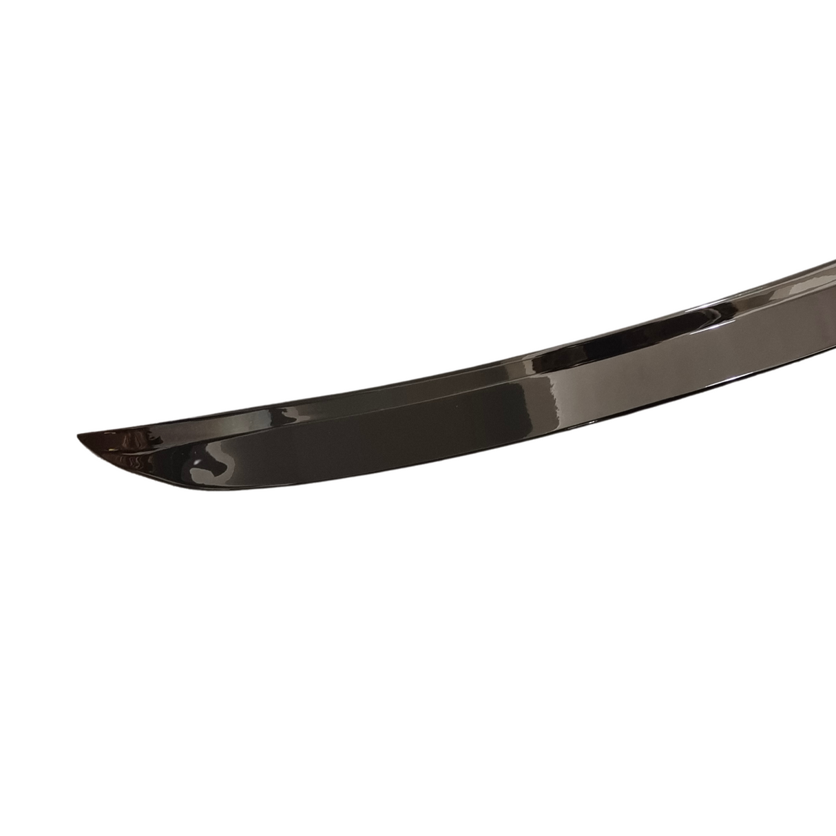 A sleek, curved sword blade with a reflective surface, set against a plain white backdrop, highlighting its polished and slightly arched design.