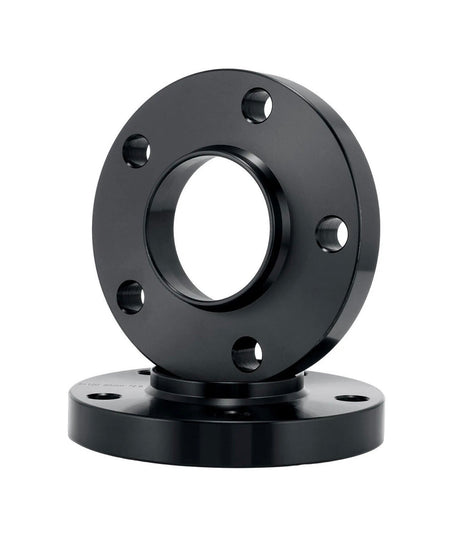 A black, cylindrical metal flange with a central hole and multiple peripheral holes is vertically stacked on a similar flange, set against a white background.