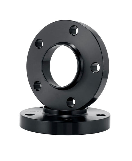 A black cylindrical flange, featuring multiple evenly spaced bolt holes, is positioned vertically on another similar flange, set against a plain white background.