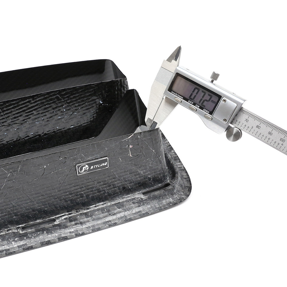 A digital caliper measures the thickness of a black, textured carbon fiber part, displaying "7.37" mm. The part features a label with "STILIND" in a professional setting.
