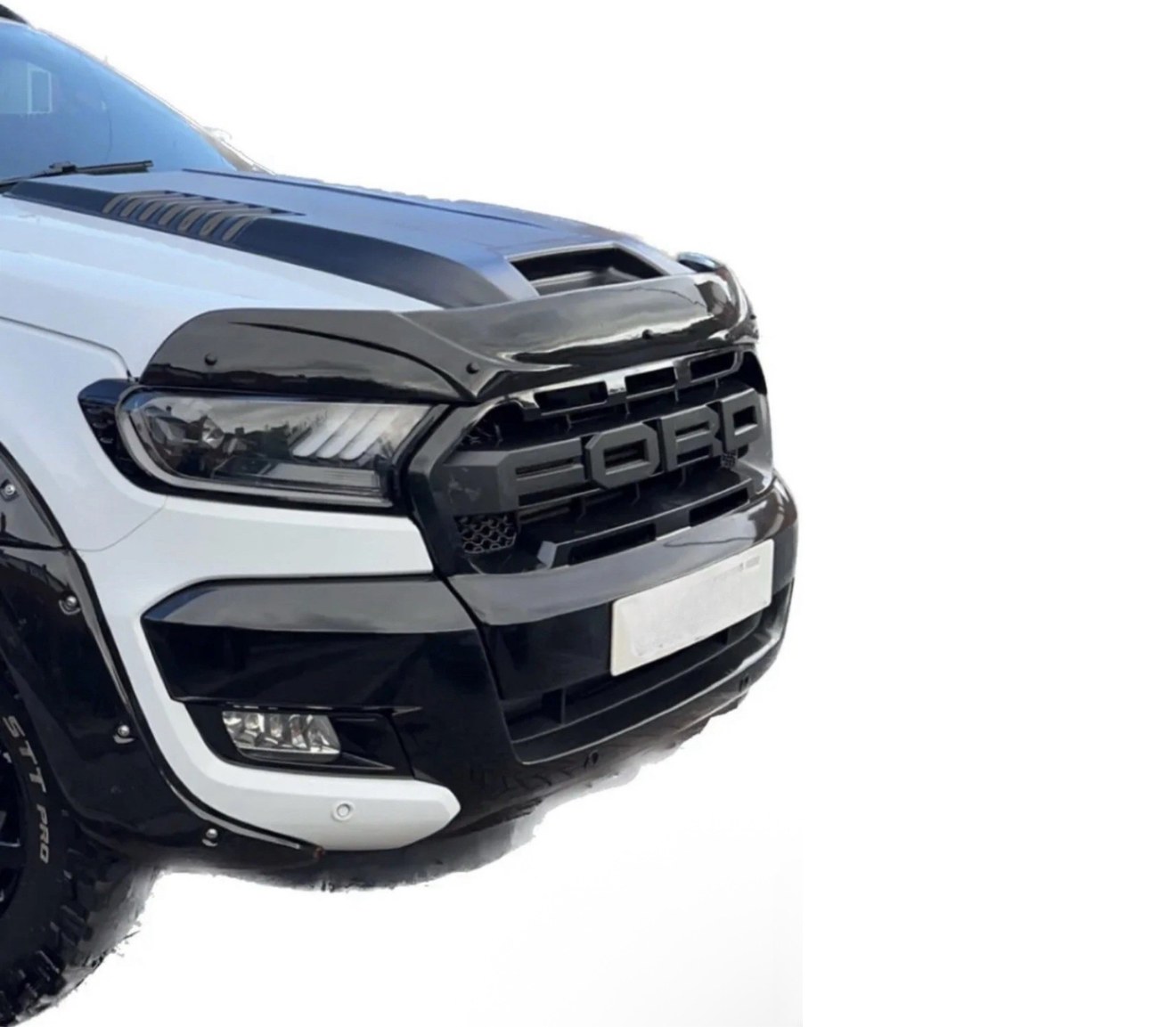 A white and black Ford truck front view, featuring a prominent grille with "FORD" text, sleek headlights, and a rugged bumper. Shown against a plain white background.
