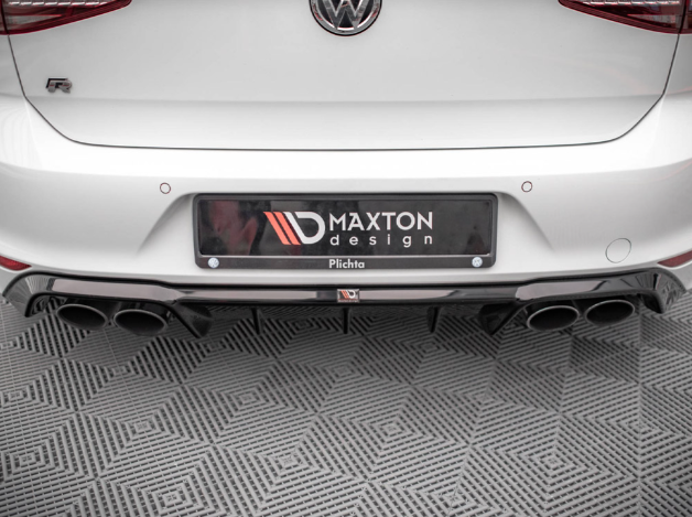 The car's rear section displays a Maxton Design bumper with a quad exhaust system, positioned on a patterned floor. The vehicle's badge and branding elements are visible.