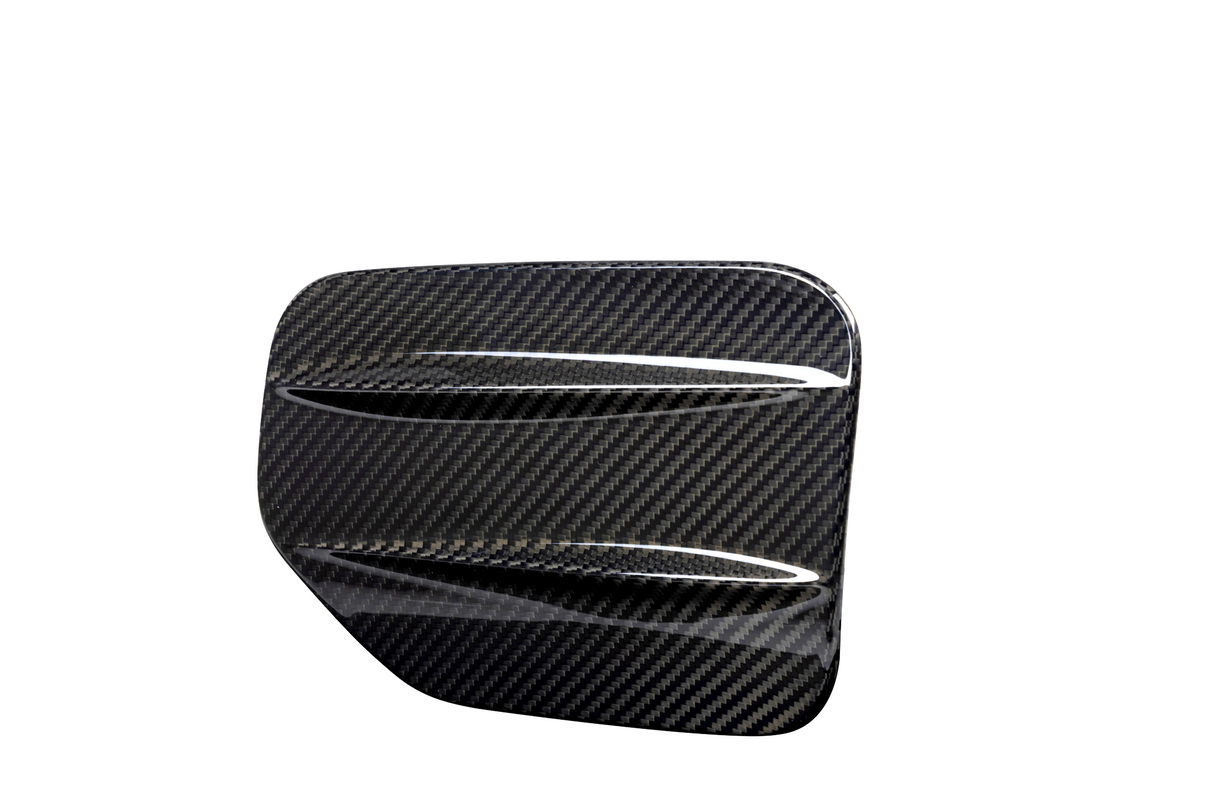 A carbon fiber automotive vent cover, angled with diagonal slats, displayed against a plain white background, emphasizing its glossy, textured surface.