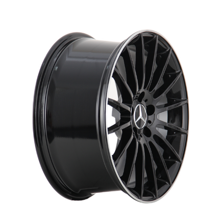 A glossy black car wheel rim features intricate spoke design radiating from the center, displaying a three-pointed star logo. The background is white, highlighting the rim's structure.