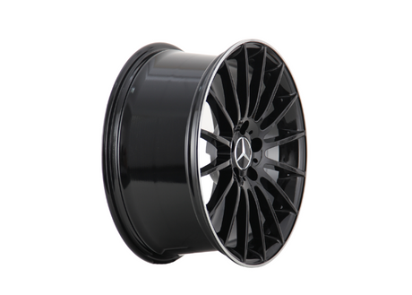A black alloy wheel with a multi-spoke design, displaying a Mercedes-Benz logo at the center, positioned against a plain white background.