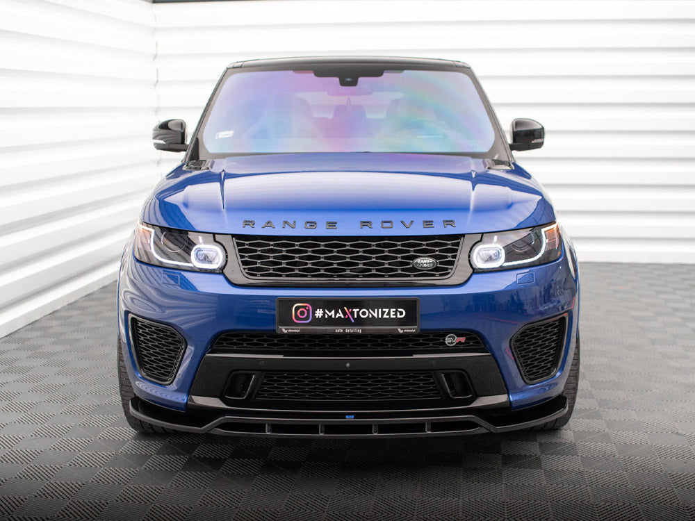 A blue Range Rover is parked indoors on a patterned floor. The front grille displays the logo, with "#MAXTONIZED" on the license plate. The setting includes white paneled walls.