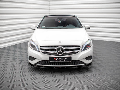 A white Mercedes-Benz car is parked in a room with patterned floors and striped walls. A front license plate reads "MAXTON design."
