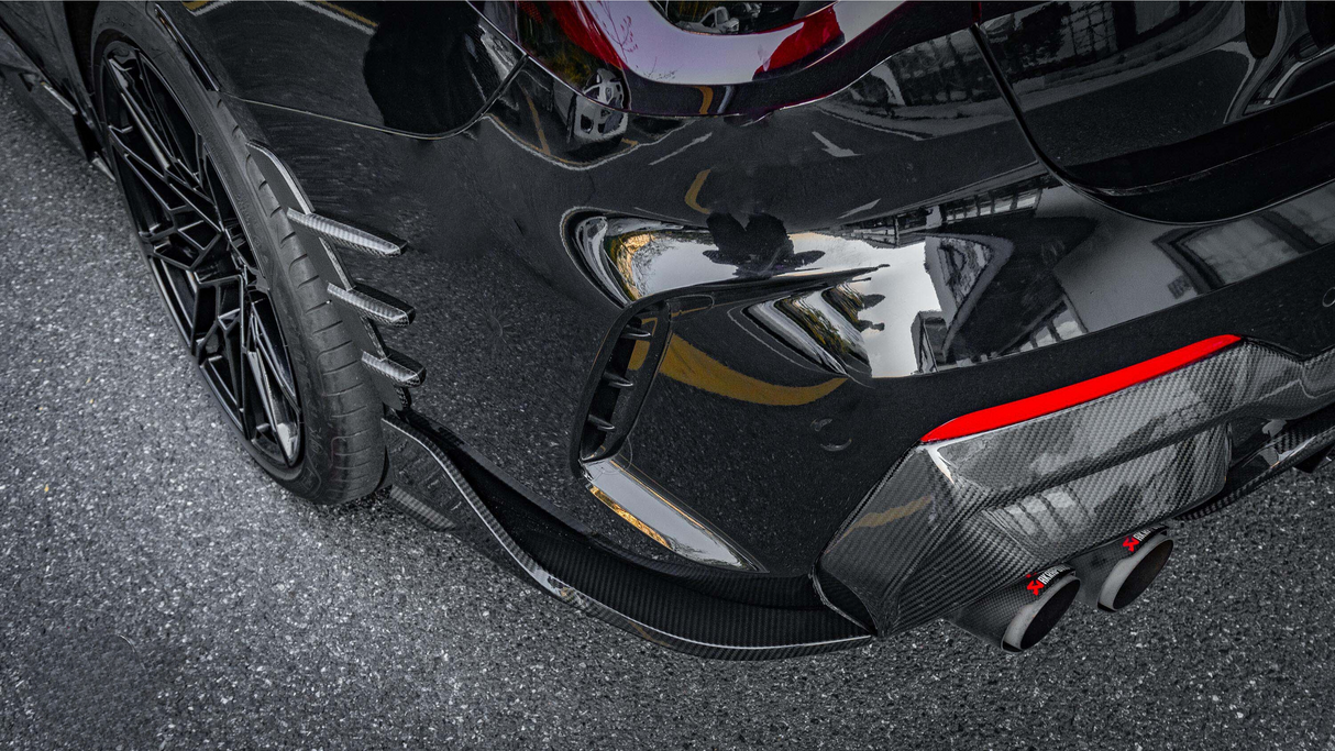 A sleek black sports car's rear is shown with dual exhaust pipes, carbon fiber detailing, and a red accent. It's parked on a textured, grey asphalt surface.