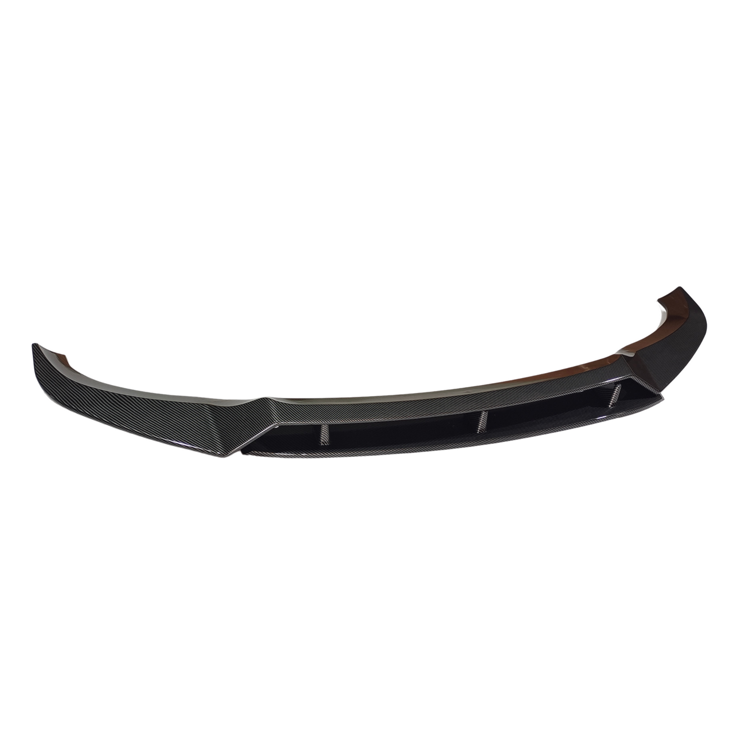 A black carbon fiber car spoiler lies on a white background, featuring a curved shape and aerodynamic design with angular edges and embedded fins.