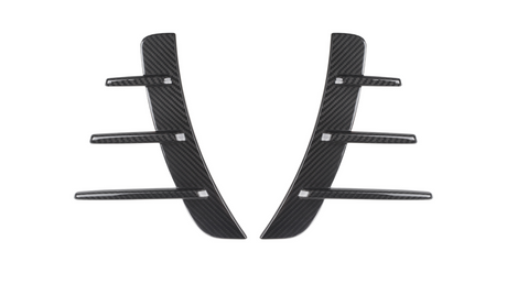 Carbon fiber car vent accents, featuring a central vertical piece with five horizontal fins, rest against a white background, showcasing their sleek and modern design.