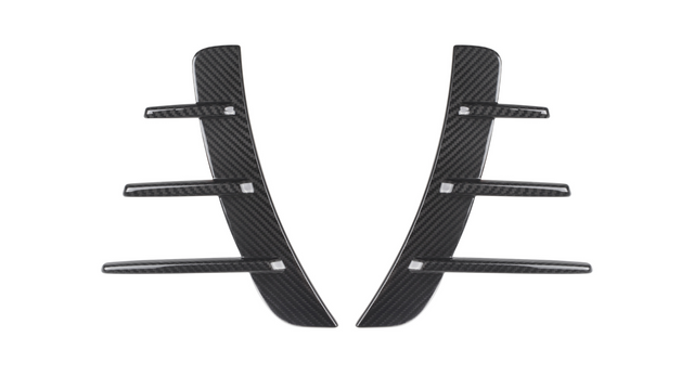 Carbon fiber car vent accents, featuring a central vertical piece with five horizontal fins, rest against a white background, showcasing their sleek and modern design.