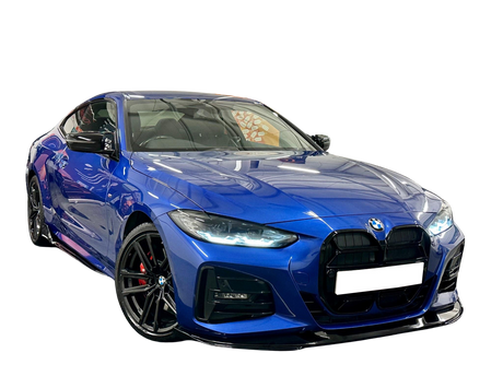 A sleek, blue BMW sports car is parked on a reflective surface, showcasing its prominent grille and polished alloy wheels against a plain black background.