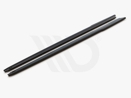 Two long, slim black bars rest parallel on a white surface. Text reads: "WORLDWIDE LEADER IN AERODYNAMIC COMPONENTS."
