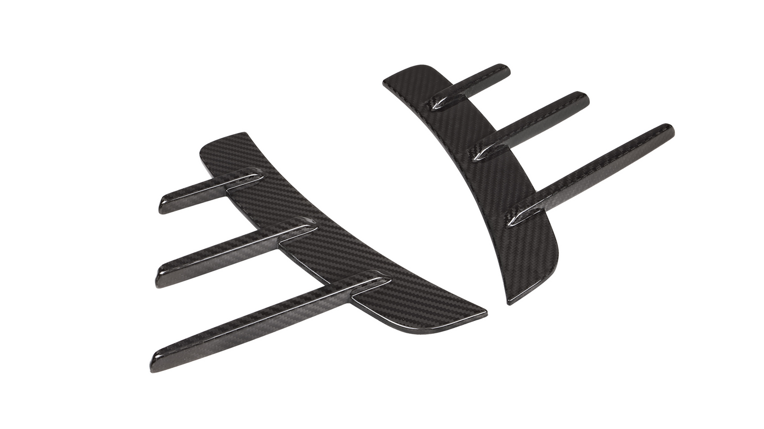 Two black carbon fiber car accessories with curved shapes and protruding fins are positioned parallel to each other on a plain white background.